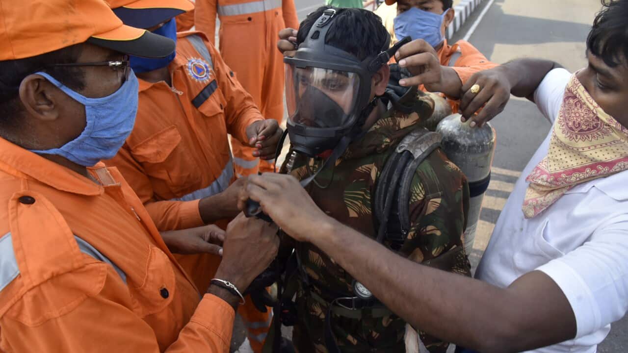 A National Disaster Response Force (NDRF) soldier is fitted with gear before he proceeds to the area from where chemical gas leaked in Vishakhapatnam