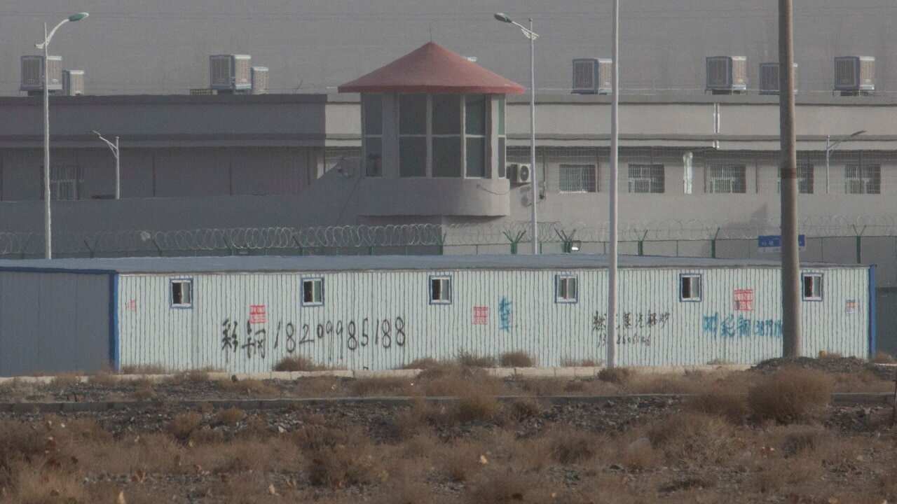 A guard tower and barbed wire fences are seen around a facility in the Kunshan Industrial Park in Artux in western China's Xinjiang region.