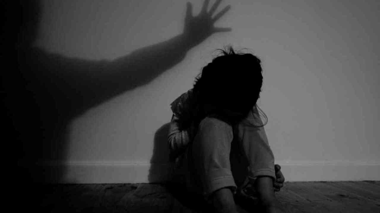 A little girl poses for photographs to illustrate the topic of child abuse