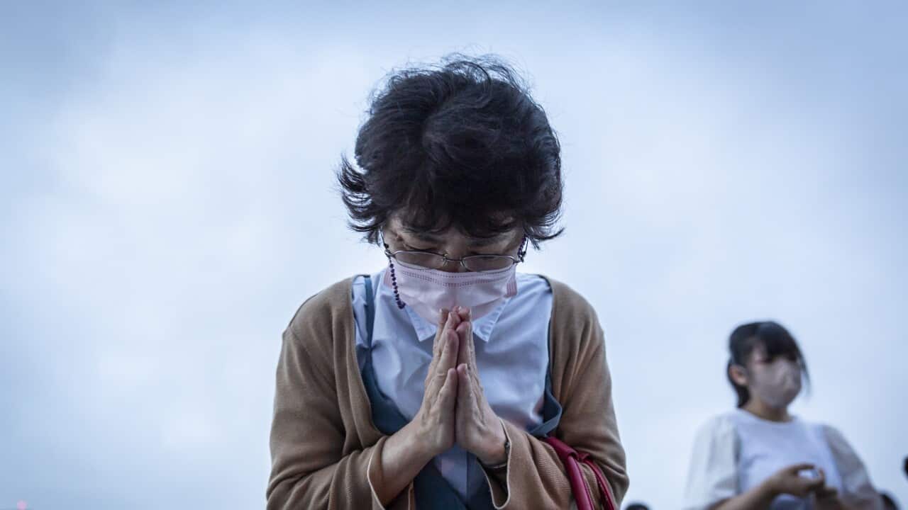 A woman prays in remembrance during the 77th anniversary of the Hiroshima atomic bombing on 6 August, 2022 in Hiroshima, Japan.