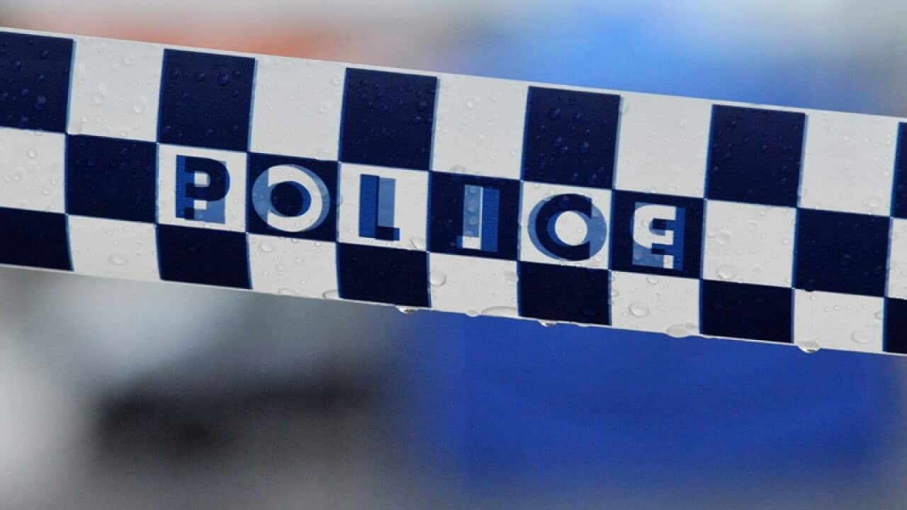 Police tape restricts access to a street