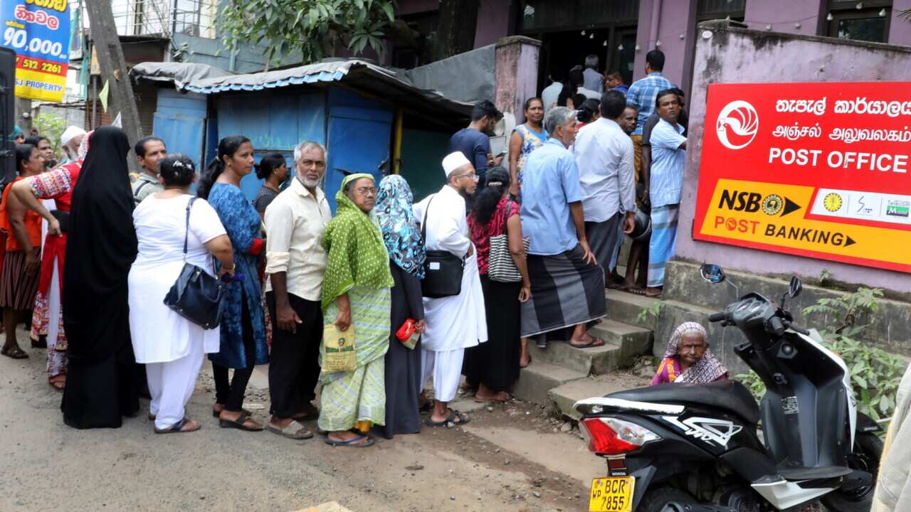 Sri Lankans queue up at a post office to collect their undelivered polling cards