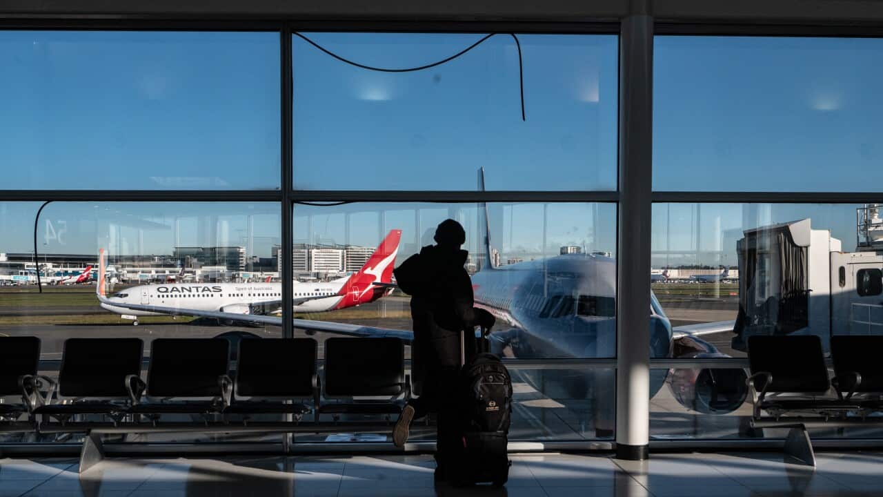 A person walking through an airport terminal.