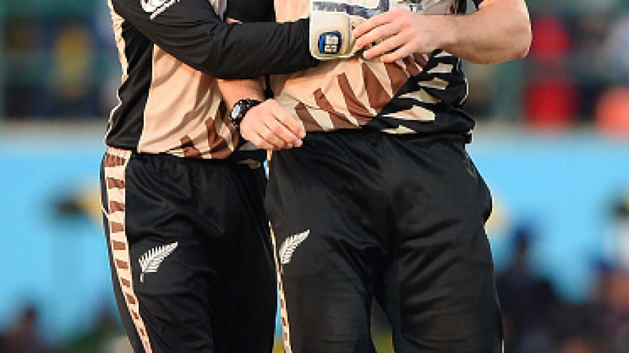 New Zealand's Mitchell McClenaghan(R)celebrates with teammate Luke Ronchi