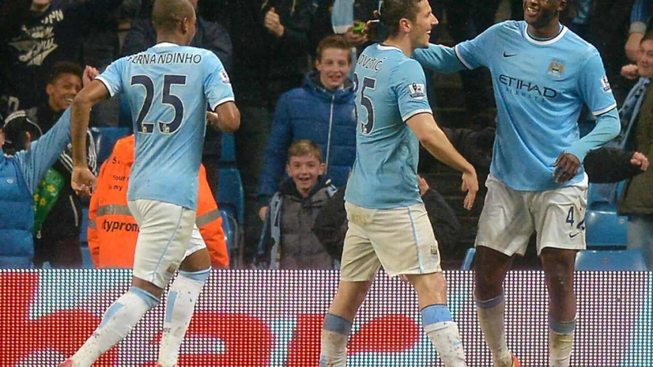 Manchester City players from (L-R) Brazil, Montenegro and Ivory Coast