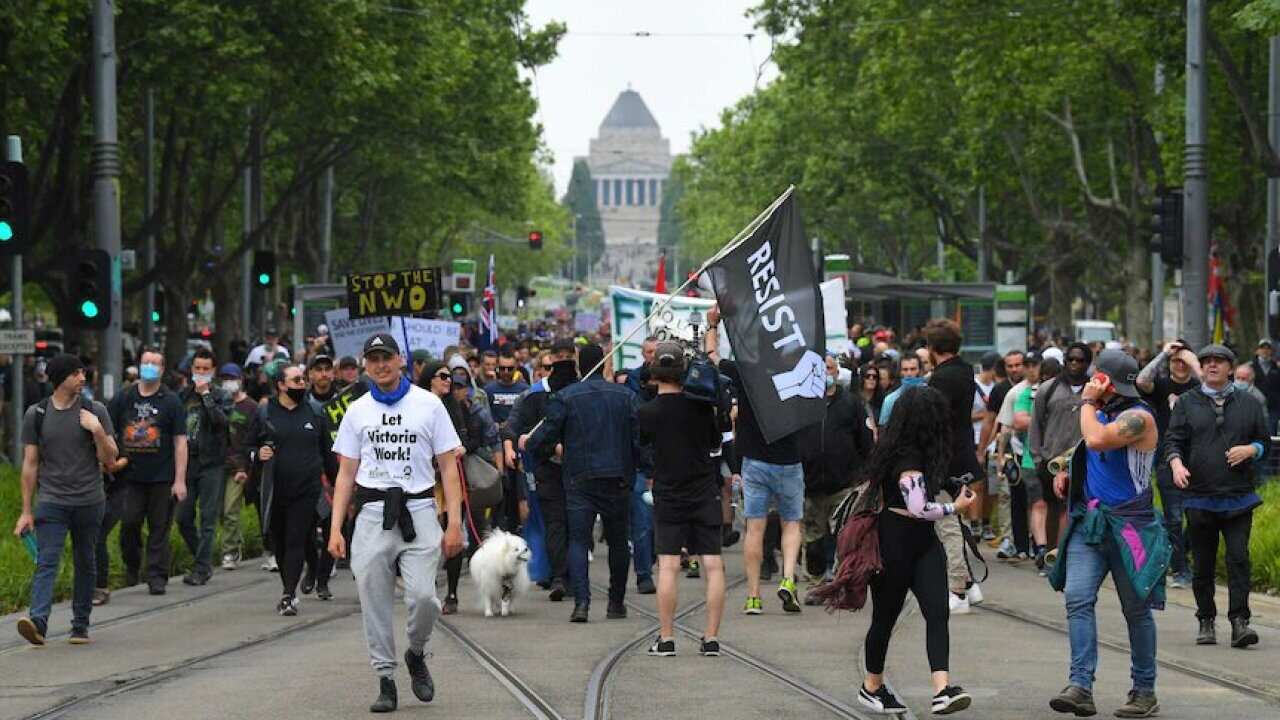 Demonstrators take to the streets to protest against COVID-19 restrictions.