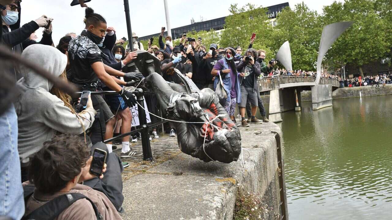 Protesters throw a statue of slave trader Edward Colston into Bristol harbour, during a Black Lives Matter protest rally, in Bristol, England.