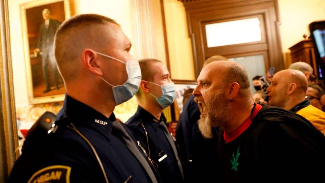 Protestors try to enter the Michigan House of Representative chamber
