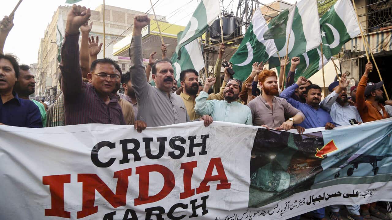Protesters carry a large banner reading "Crush India March" during a rally in Hyderabad, Pakistan, on May 10, 2025, after the ceasefire agreement announcement between the two countries.