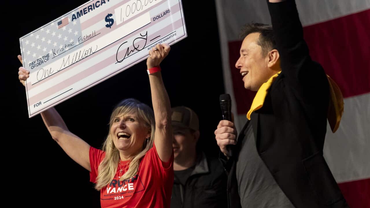 A woman holding up a sign
