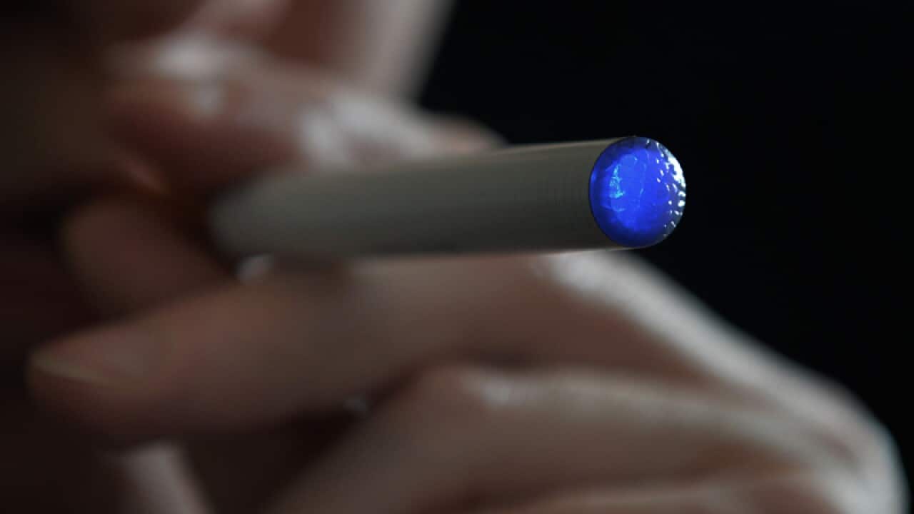 A person smoking an e-cigarette