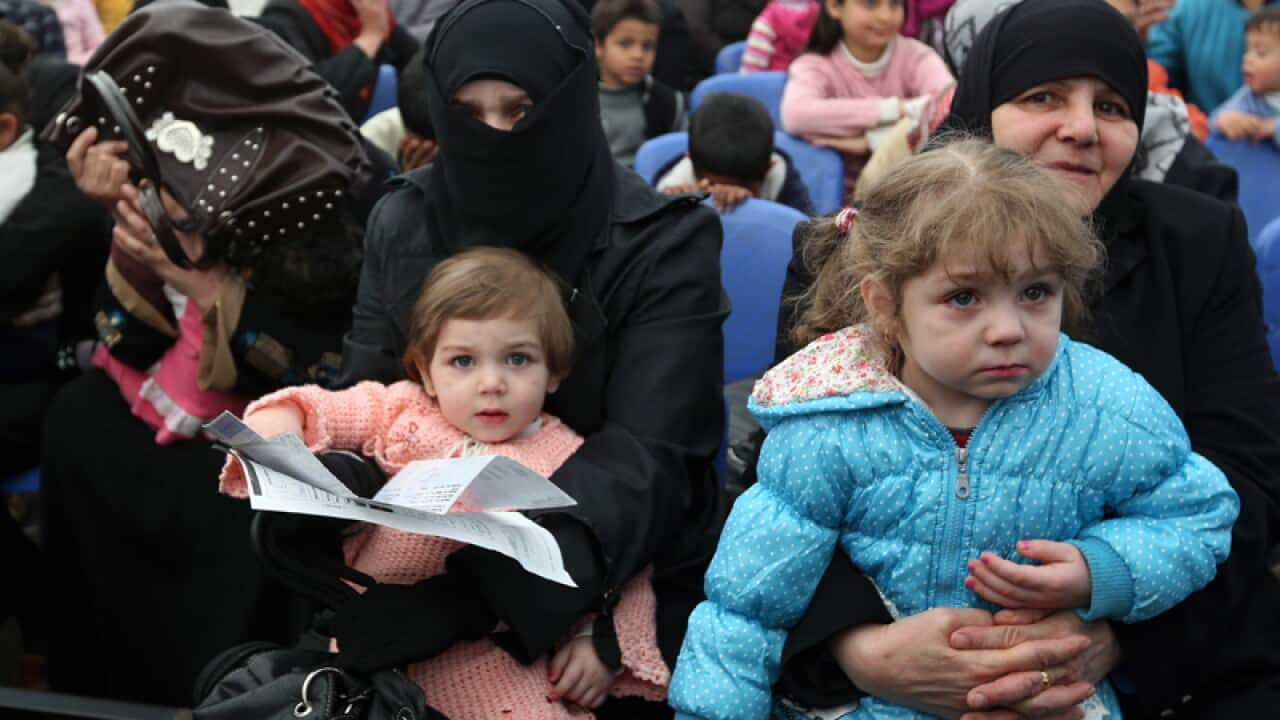 Syrian families wait to register as refugees in Lebanon