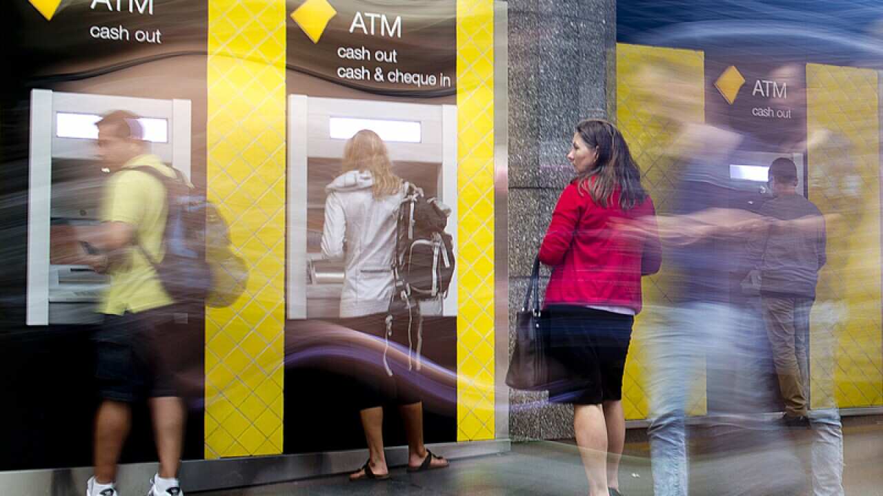 People using ATM at the Commonwealth Bank in the Brisbane