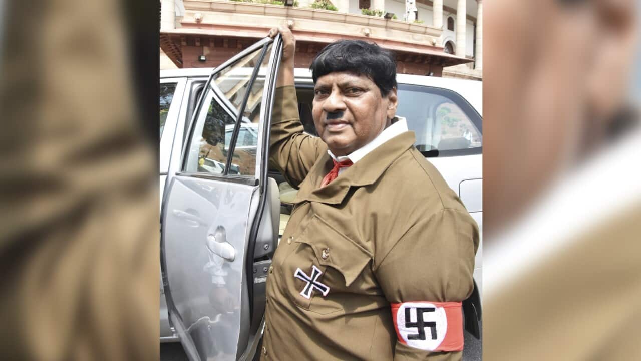 ndian lawmaker Naramalli Sivaprasa stands dressed like Adolf Hitler outside the Indian parliament building in New Delhi, India, Friday, Aug. 10, 2018.