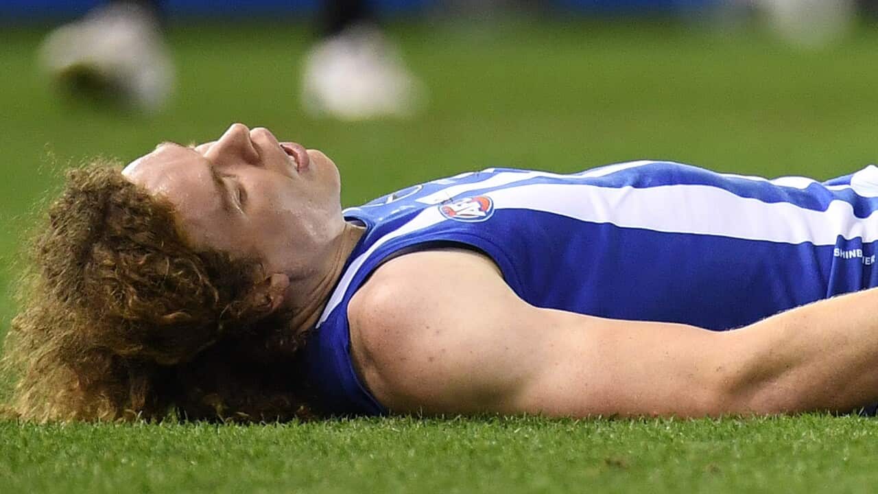 Ben Brown of the Kangaroos is seen after suffering a concussion during an AFL match (AAP)