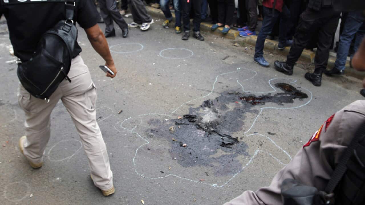 An outline of a body is seen at the scene of a bomb blast, Jakarta