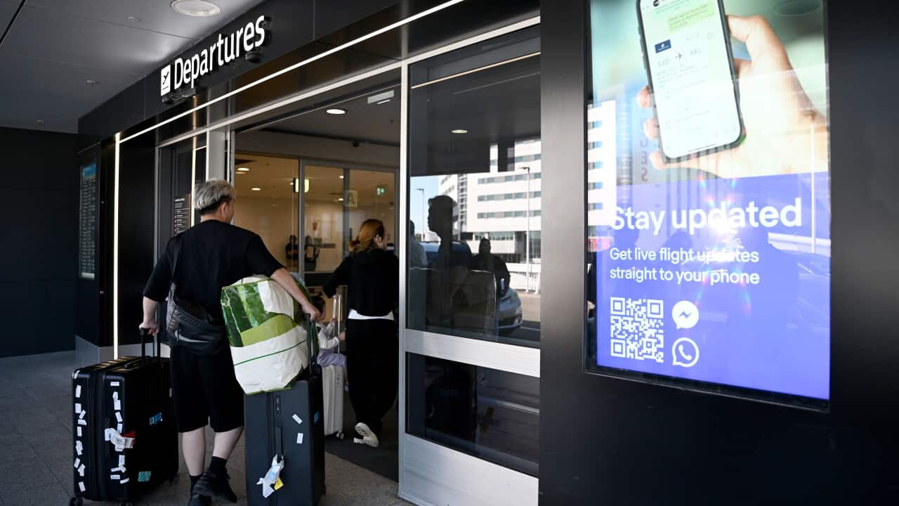Travellers are seen at the Departures terminal of the Sydney International Airport