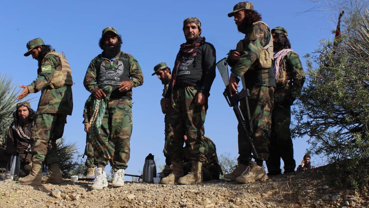 Afghan servicemen guard along the border with Pakistan (AAP)