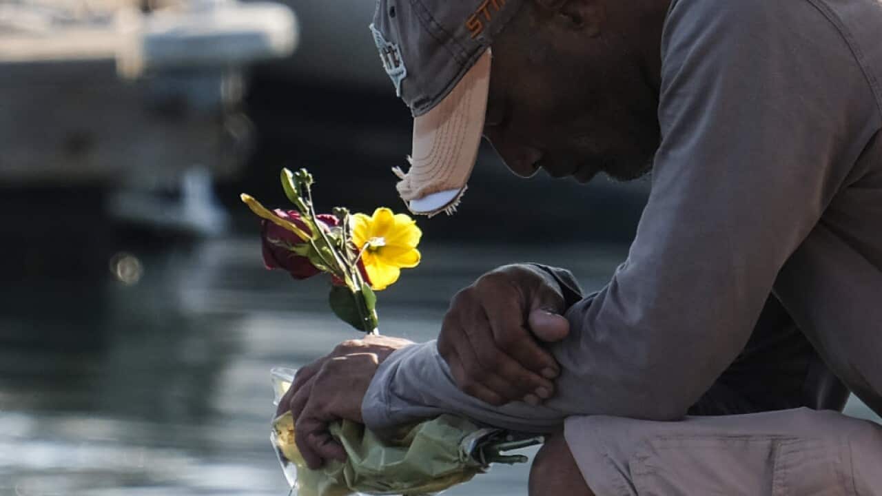 A man seen reflecting at a dock near the Sea Landing at Santa Barbara Harbor