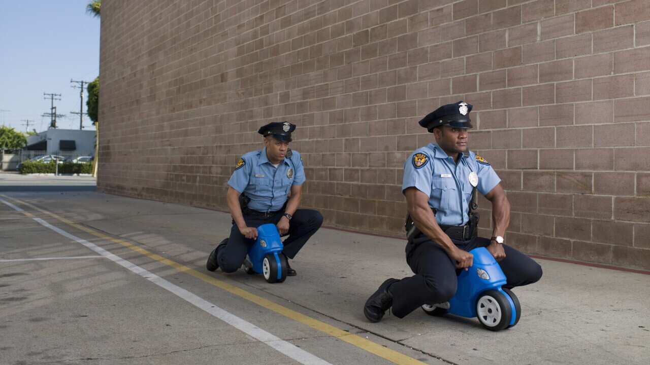 men in police uniforms riding toy motorcycles
