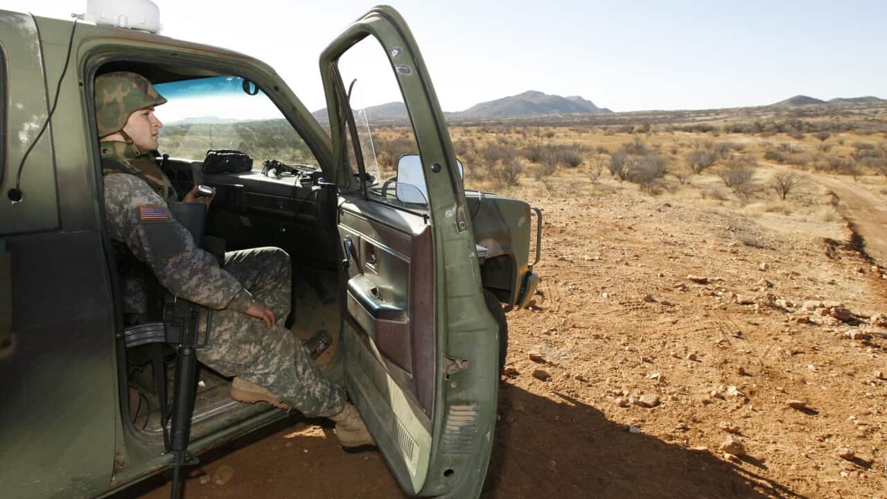 In this Friday, Jan. 19, 2007 file photo, a National Guard unit patrols at the Arizona-Mexico border in Sasabe, Ariz.