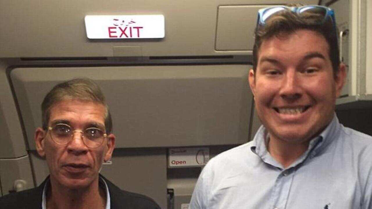 British man Ben Innes (R) poses for a bizarre photo with alleged hijacker Seif Eldin Mustafa (L). (Supplied)