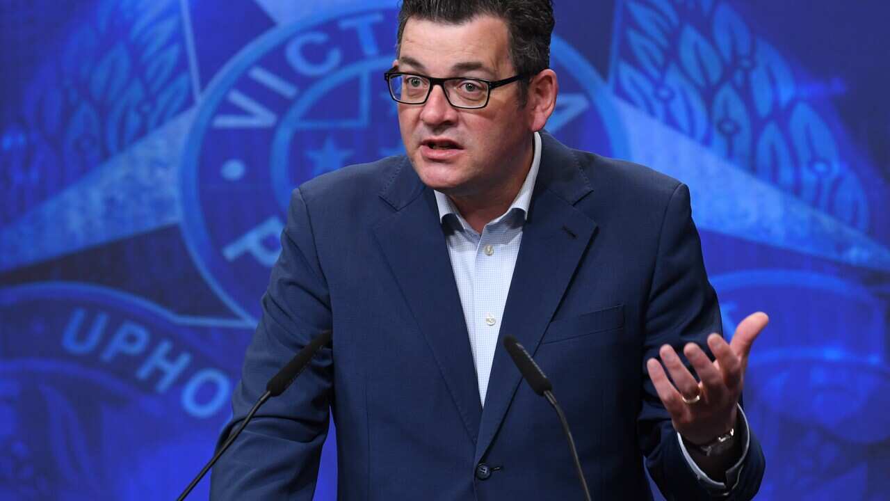 Victorian Premier Daniel Andrews standing behind a lectern and speaking