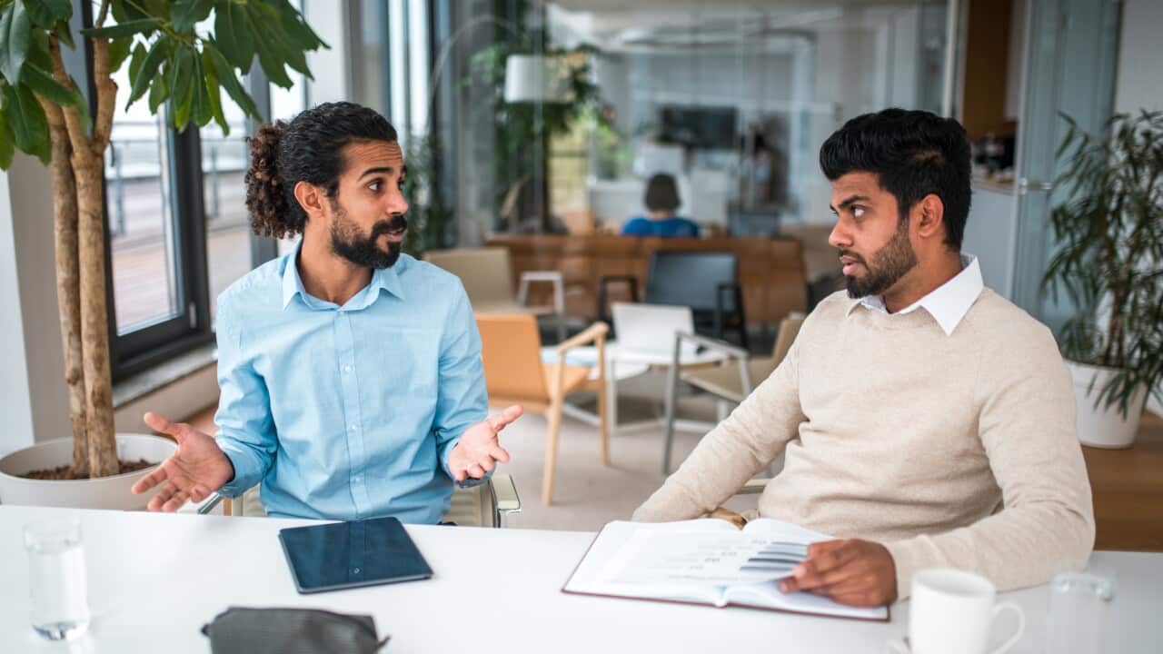 Two Mid Adult Men Disagreeing at Work