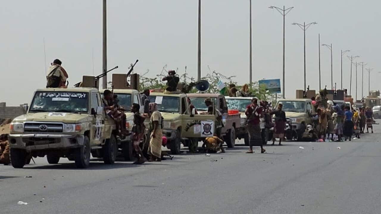 Yemeni pro-government forces gather on a highway on the eastern outskirts of Hodeida.