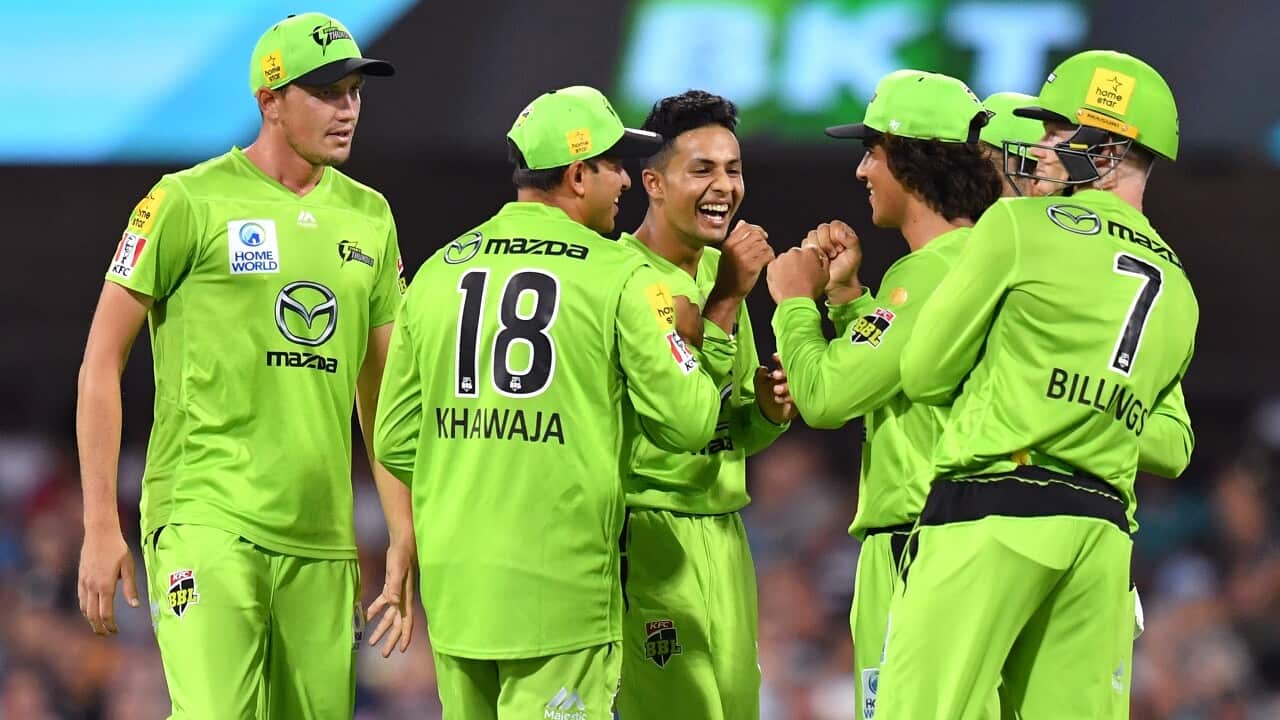 Tanveer Sangha (centre) of the Thunder during the Big Bash League match between the Brisbane Heat and Sydney Thunder at the Gabba in Brisbane, Jan 4, 2021.