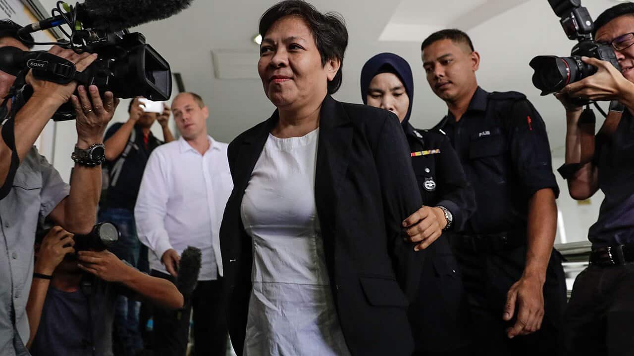 Australian Maria Elvira Pinto Exposto (C), escorted by Royal Malaysian Police (RMP) officers.