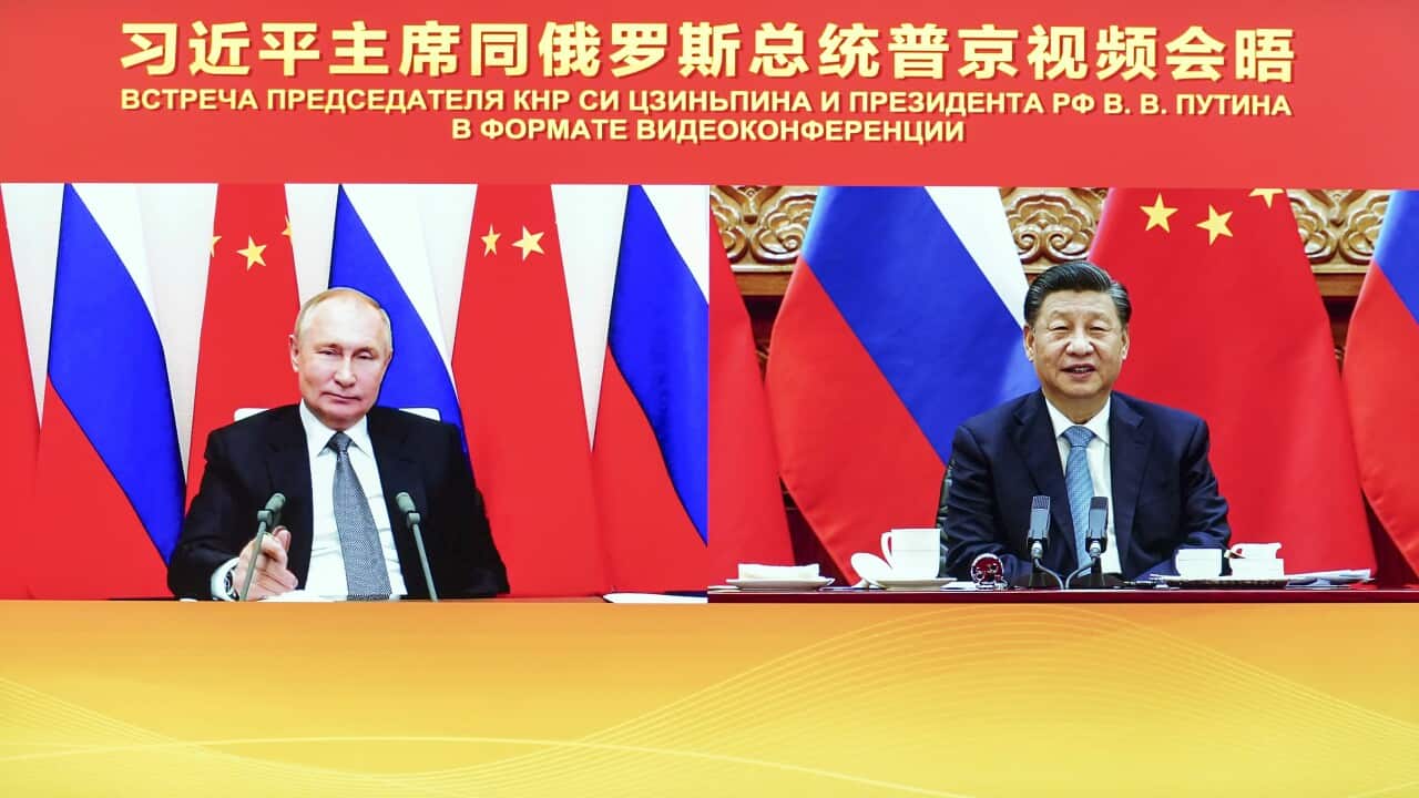 Chinese President Xi Jinping, right, attends a virtual meeting with Russian President Vladimir Putin