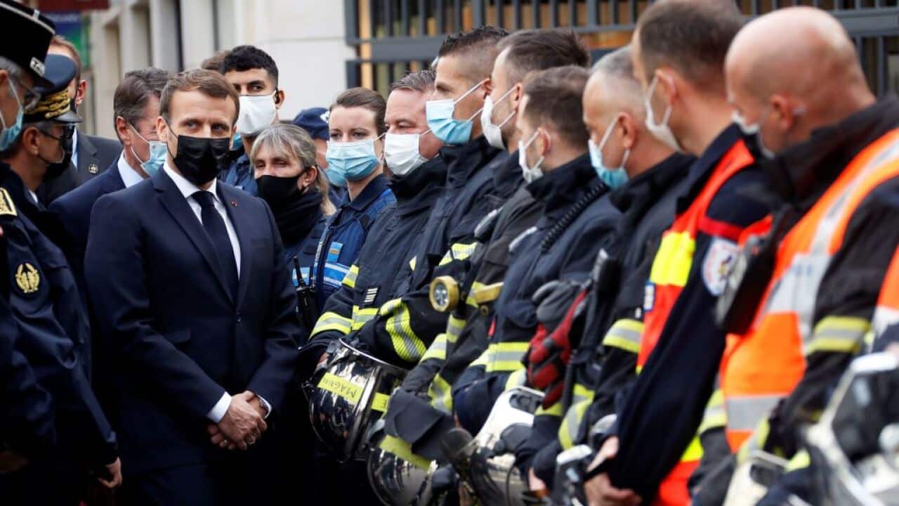 French President Emmanuel Macron (1st-L) visits the scene of a knife attack at the Basilica of Notre-Dame de Nice in Nice on 29 October.