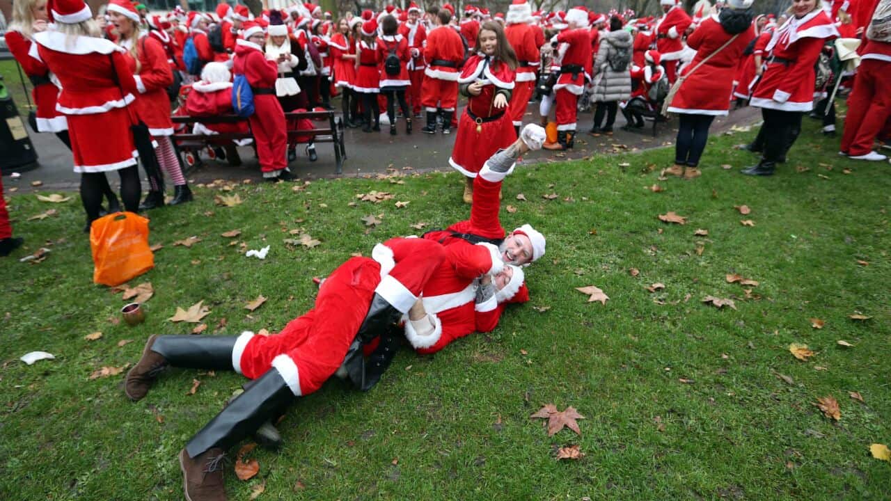 Revellers dressed in Santa suits wrestle outside Euston railway station in London, as they take part in the Santacon Christmas parade.. Picture date: Saturday December 10, 2016. Photo credit should read: Jonathan Brady/PA Wire