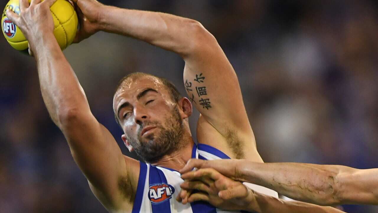 Ben Cunnington of the Kangaroos (left)