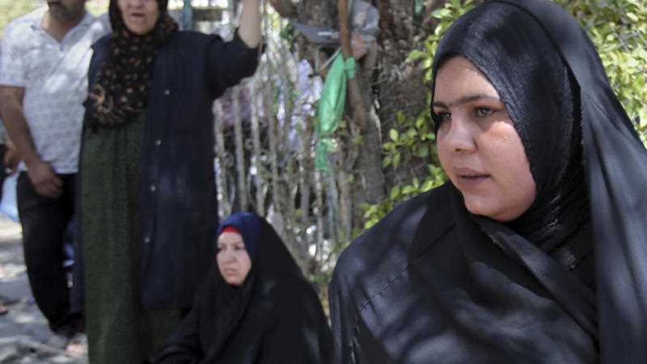 Families of newborn babies who died in a fire gather outside a maternity ward at Yarmouk hospital in western Baghdad