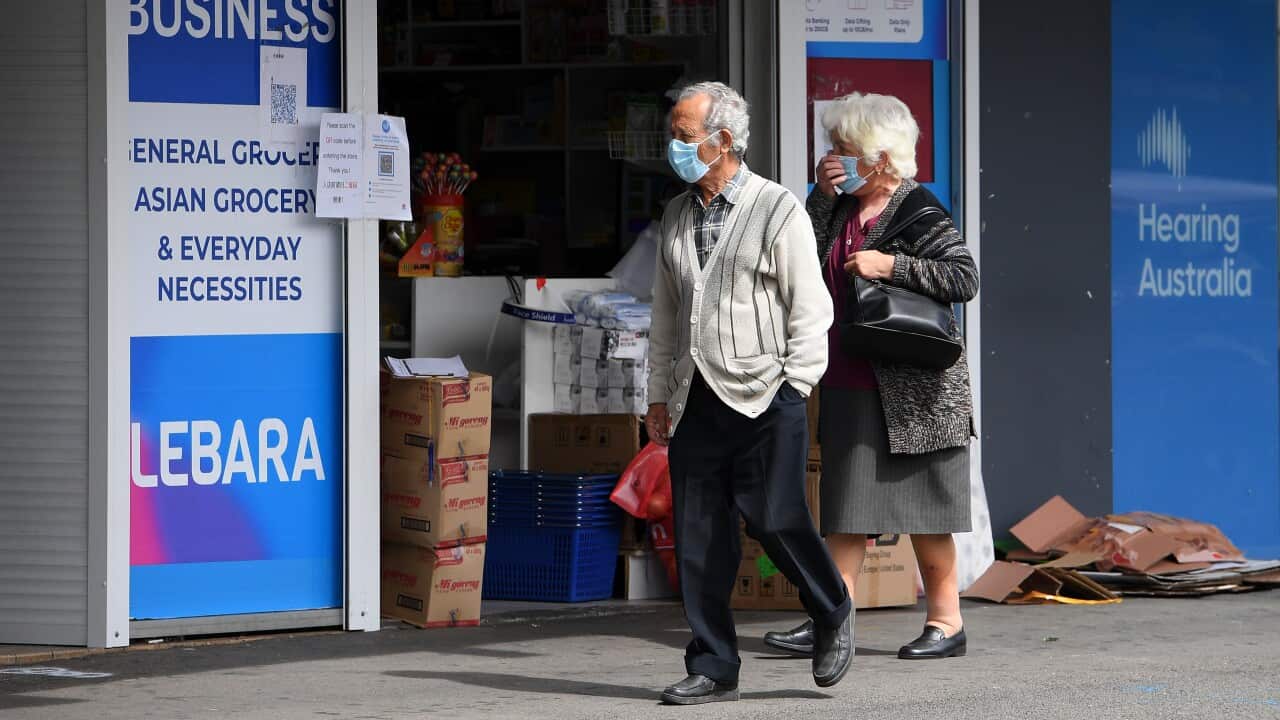 Two people wearing mask on a street