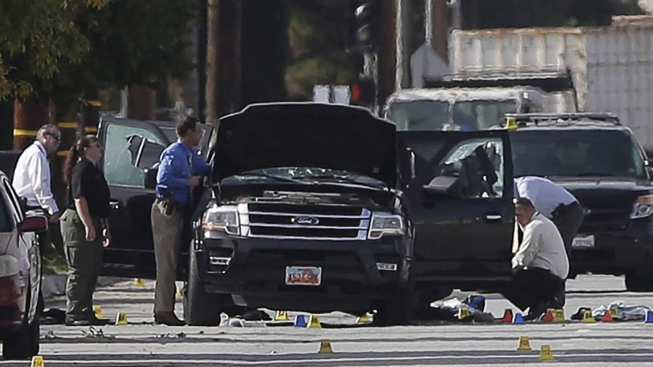 Police officers investigate the scene of a shooting in California