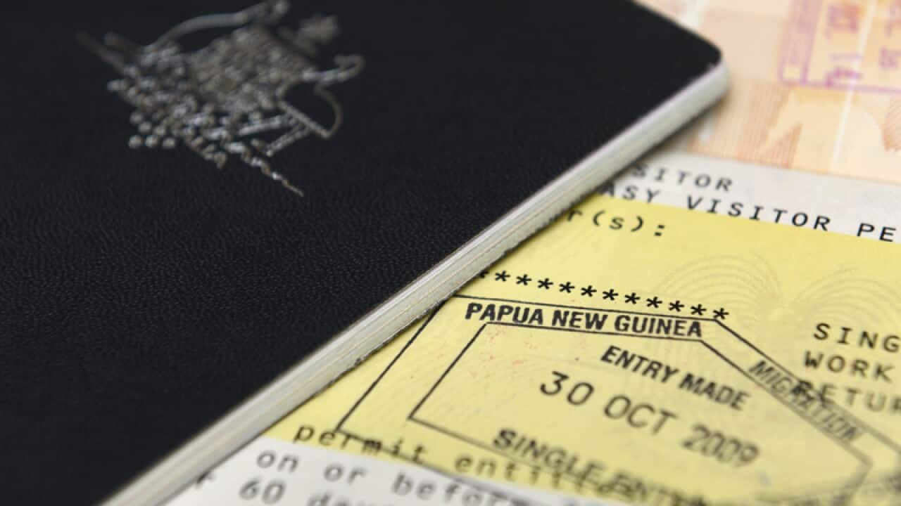 An Australian passport is pictured next to a visa to Papua New Guinea
