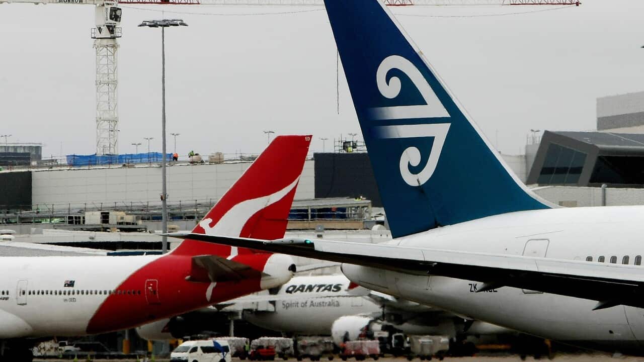 The tails of a Qantas airline plane (L)