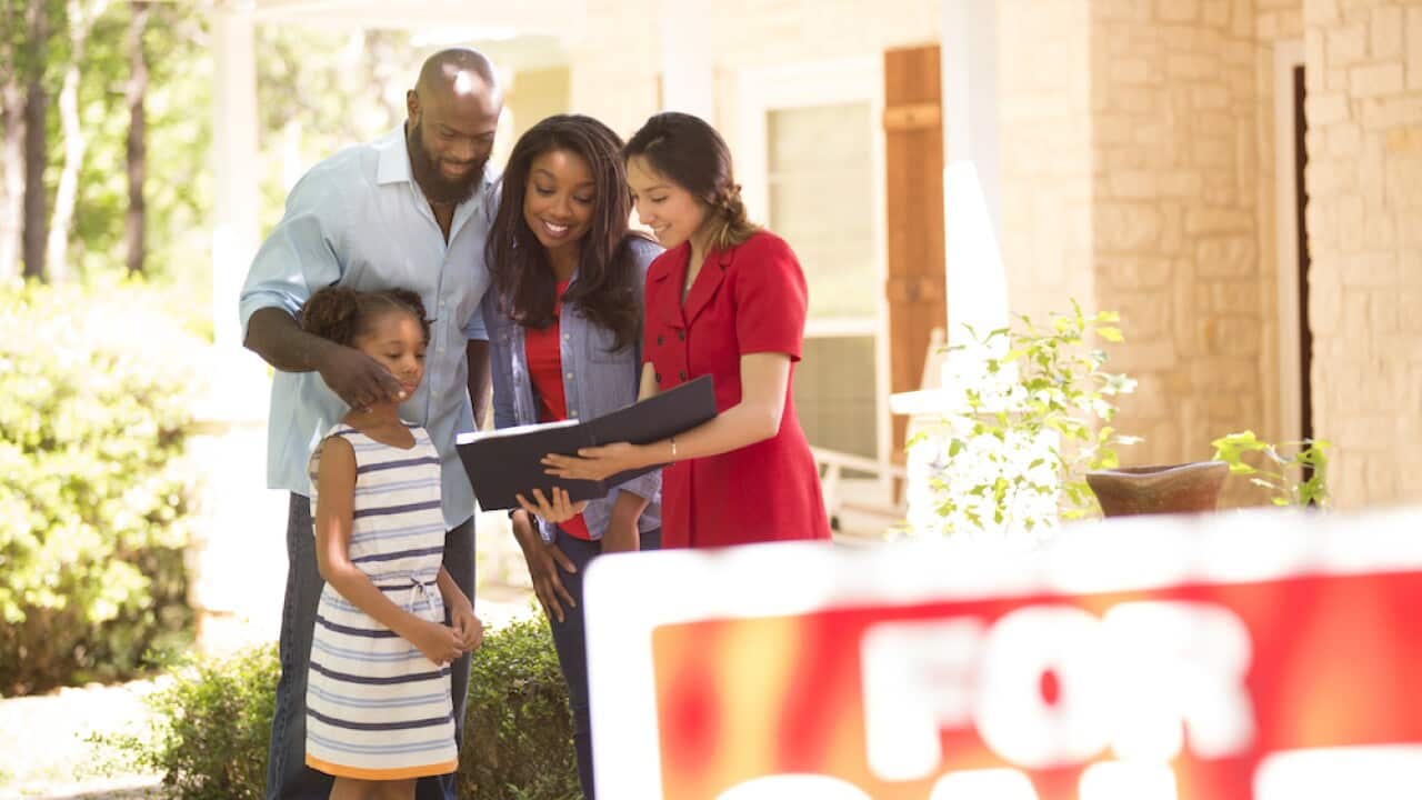 Realtor and family looking at new home to purchase.