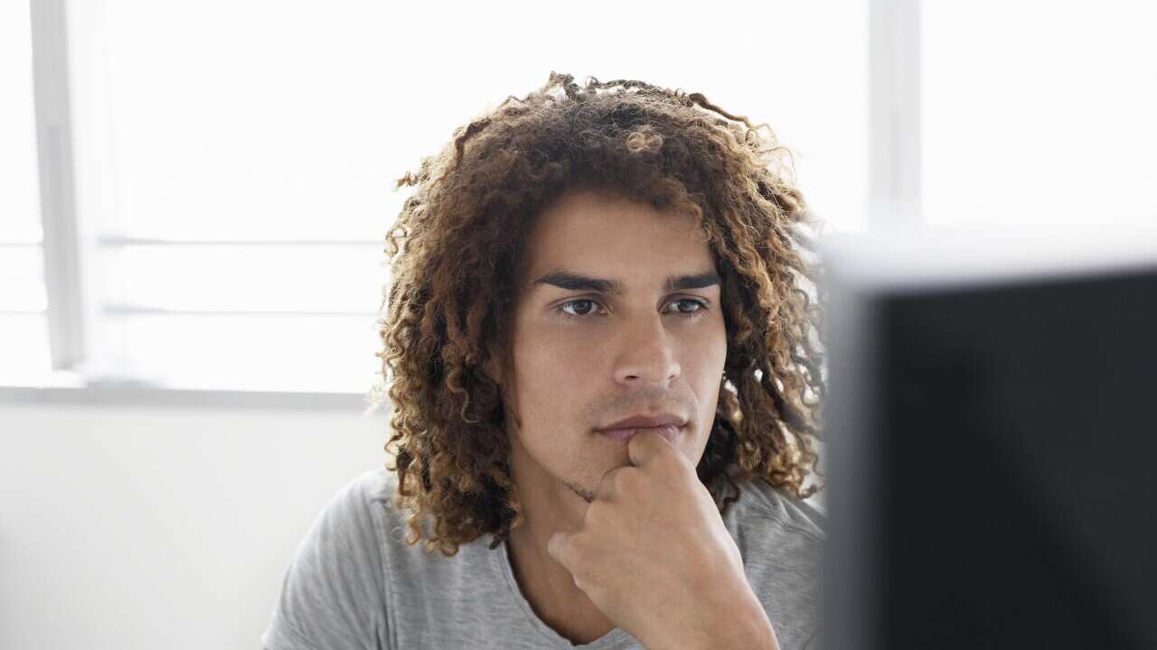 Young man in t-shirt using computer