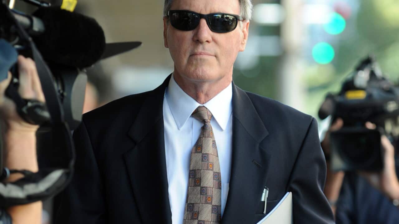 Robert Hughes leaves the Downing Centre court in Sydney