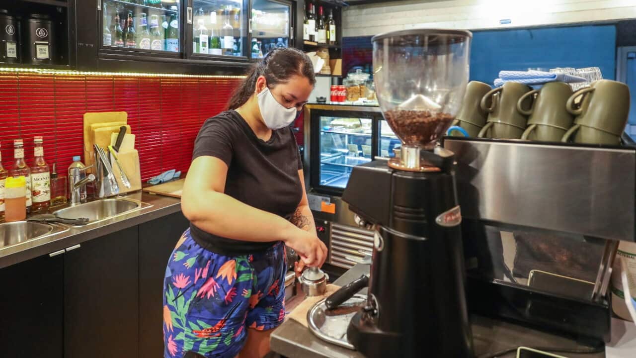 A barista prepares a coffee at a cafe in Melbourne.