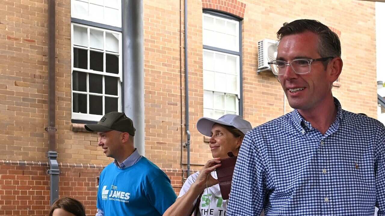 NSW Premier Dominic Perrottet and Liberal candidate Tim James at Cammeray Public School on 12 February 2022.