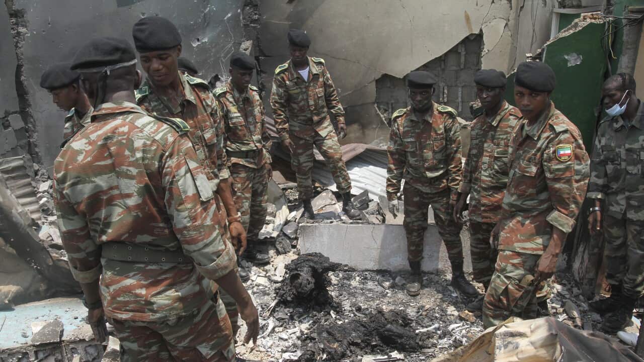 Military personnel view debris in the aftermath of a deadly explosion in Bata, Equatorial Guinea, 8 March,2021.