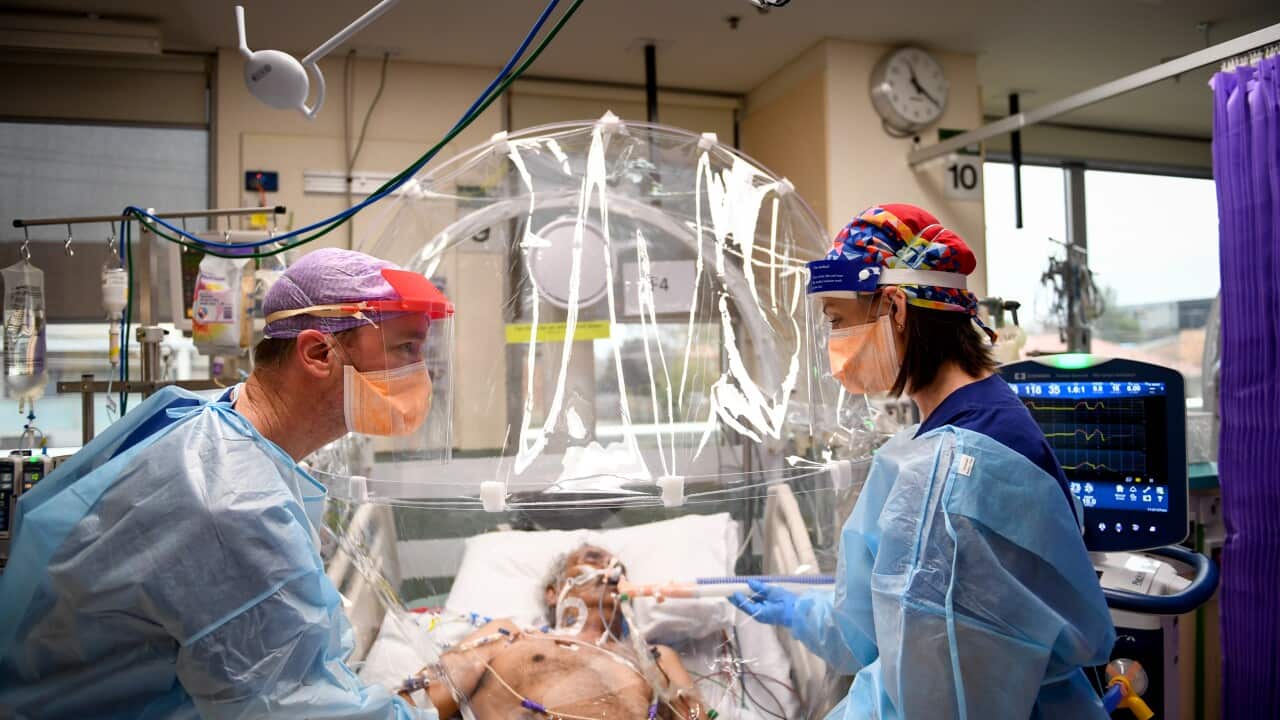 ICU nurse Michelle Spiteri and anaesthetist and intensive care physician Dr Forbes McGain attending to a Covid-19 patient.