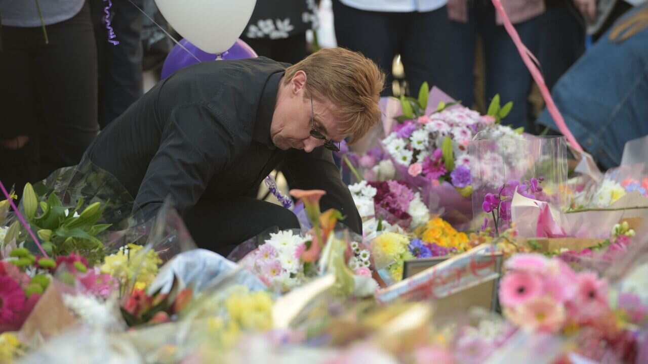 People during a vigil at St Ann's Square in Manchester.