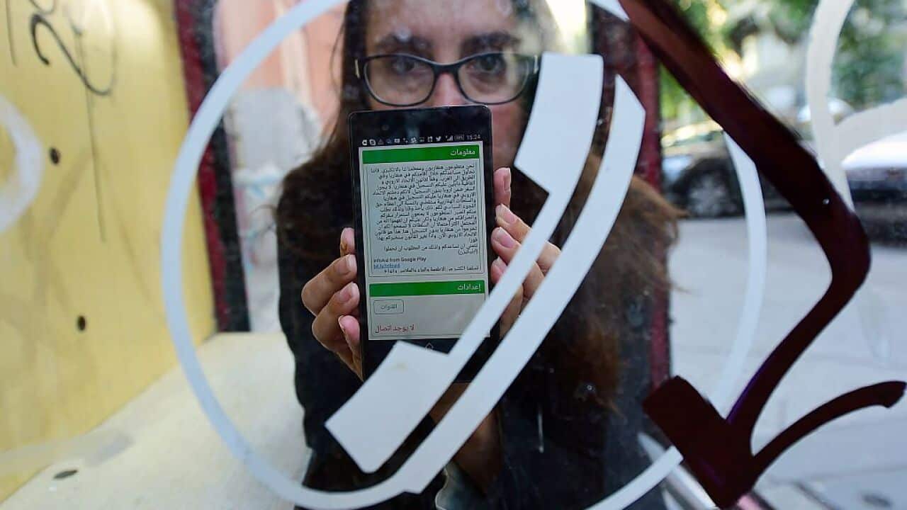 Nina Tov, one of the Hungarian brainchilds behind the InfoAid smartphone app, shows her phone.