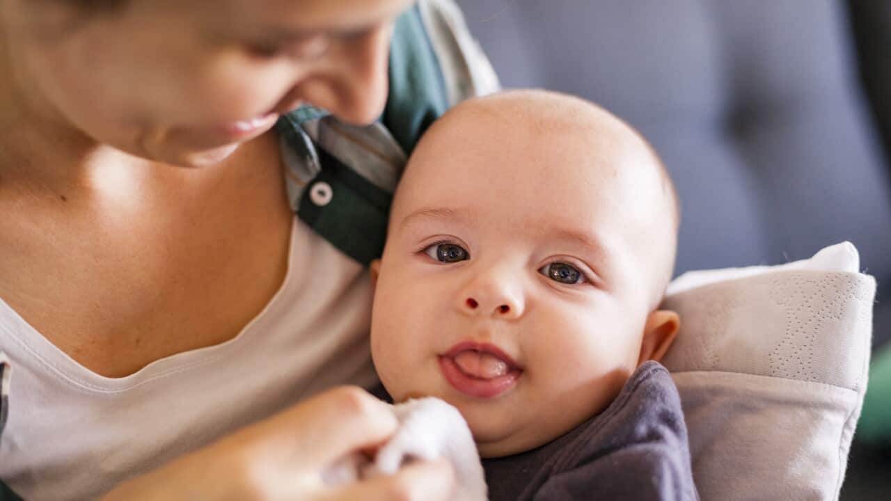 Mother cuddling with her baby son